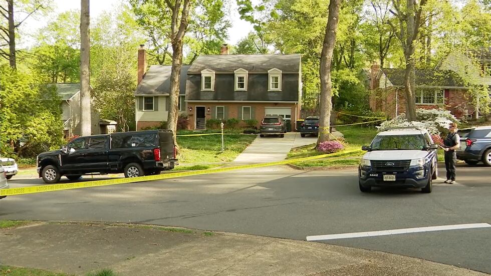 Police investigate the scene of an apparent domestic-related shooting early Thursday, April...
