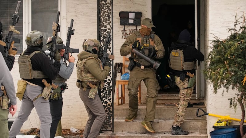 Federal immigration Federal immigration officers prepare to enter a Minneapolis home to make...