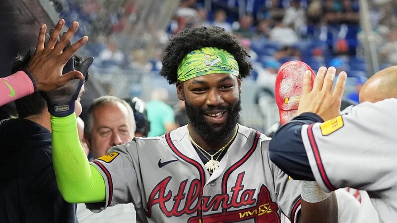 Michael Harris II de los Bravos de Atlanta es felicitado tras anotar un elevado de sacrificio...